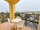 Private balcony with table and chairs, offering an outdoor seating area at 8100 Poinciana Blvd # 2405, Orlando, FL 32821
