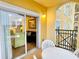 Private balcony with table and chairs, offering views of the building and partial interior view at 8100 Poinciana Blvd # 2405, Orlando, FL 32821
