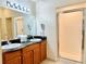 Double vanity bathroom with granite countertops and a large shower at 8100 Poinciana Blvd # 2405, Orlando, FL 32821