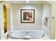 Large soaking tub with wall art and towels at 8100 Poinciana Blvd # 2405, Orlando, FL 32821
