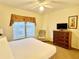 Bedroom with king-size bed, dresser, and ceiling fan at 8100 Poinciana Blvd # 2405, Orlando, FL 32821