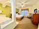 Main bedroom with king-size bed and a jacuzzi tub at 8100 Poinciana Blvd # 2405, Orlando, FL 32821
