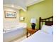 Bedroom with a king bed and adjacent jacuzzi tub at 8100 Poinciana Blvd # 2405, Orlando, FL 32821
