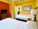 Bedroom with two twin beds, dresser, and view of kitchenette at 8100 Poinciana Blvd # 2405, Orlando, FL 32821