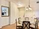 Bright dining area with a glass table, upholstered chairs, and neutral decor at 8100 Poinciana Blvd # 2405, Orlando, FL 32821