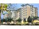 Luxury condo building boasts an appealing facade and beautifully manicured landscaping at 8100 Poinciana Blvd # 2405, Orlando, FL 32821