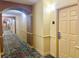 Well-maintained hallway leads to apartments within a building with secure key-card access at 8100 Poinciana Blvd # 2405, Orlando, FL 32821