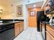 Functional kitchen with black appliances, granite countertops, and wood cabinets at 8100 Poinciana Blvd # 2405, Orlando, FL 32821
