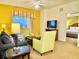 Comfortable living room with a sofa, armchairs, and a view of the bedroom at 8100 Poinciana Blvd # 2405, Orlando, FL 32821