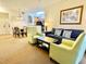 Living room features a sofa, armchairs, coffee table, and dining area at 8100 Poinciana Blvd # 2405, Orlando, FL 32821