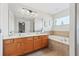 Double vanity bathroom with soaking tub and window at 901 Marcello Blvd, Kissimmee, FL 34746