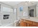 Bathroom with shower, toilet and wood vanity at 901 Marcello Blvd, Kissimmee, FL 34746