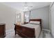 Cozy bedroom featuring wood flooring and ensuite bathroom at 901 Marcello Blvd, Kissimmee, FL 34746
