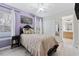 Bright bedroom with purple walls and double closet at 901 Marcello Blvd, Kissimmee, FL 34746