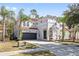 Two-story house with gray exterior, tile roof, and a two-car garage at 901 Marcello Blvd, Kissimmee, FL 34746