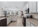 Open kitchen with white cabinets and stainless steel appliances at 901 Marcello Blvd, Kissimmee, FL 34746