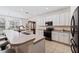 Modern kitchen featuring white cabinets, stainless steel appliances, and an island at 901 Marcello Blvd, Kissimmee, FL 34746