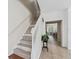Modern staircase with wood-look flooring and white railing at 901 Marcello Blvd, Kissimmee, FL 34746