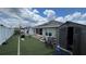 Large backyard with artificial turf, shed, and solar panels at 1015 Sabine Pl, Kissimmee, FL 34759