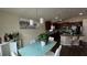 Dining area with glass-top table and view into the kitchen at 1015 Sabine Pl, Kissimmee, FL 34759
