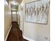 Bright hallway with dark wood floors and large art piece at 1015 Sabine Pl, Kissimmee, FL 34759