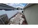 Landscaped side yard with a walkway and white fence at 1015 Sabine Pl, Kissimmee, FL 34759