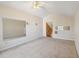 Large bonus room with mirrored wall and ceiling fan at 10398 Stone Glen Dr, Orlando, FL 32825