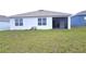 Grass backyard with home exterior view at 1057 Cambridge Dr, Winter Haven, FL 33881