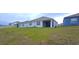 Spacious backyard with grassy area and screened patio at 1057 Cambridge Dr, Winter Haven, FL 33881