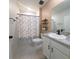 Clean bathroom with tub shower, vanity, and shelves at 1057 Cambridge Dr, Winter Haven, FL 33881