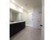 Bathroom with double vanity, shower, and linen closet at 1057 Cambridge Dr, Winter Haven, FL 33881