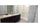 Bathroom with double vanity, granite countertop, and shower at 1057 Cambridge Dr, Winter Haven, FL 33881