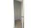 Small closet with a single rod for hanging clothes at 1057 Cambridge Dr, Winter Haven, FL 33881