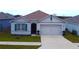 One-story house with a two-car garage and landscaped lawn at 1057 Cambridge Dr, Winter Haven, FL 33881