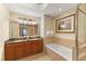 Bright bathroom featuring double vanity, soaking tub, and walk-in shower at 1108 Sunset View Cir # 204, Reunion, FL 34747