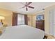 Inviting bedroom with a plush bed, ceiling fan, and ample closet space at 1108 Sunset View Cir # 204, Reunion, FL 34747
