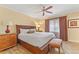 Inviting bedroom with a plush king bed, ceiling fan, and ample natural light at 1108 Sunset View Cir # 204, Reunion, FL 34747