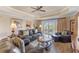Comfortable living room featuring leather sofas and access to a private balcony at 1108 Sunset View Cir # 204, Reunion, FL 34747