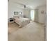 Bright bedroom with neutral carpet, ceiling fan, and a large window at 1158 Sand Torch, Davenport, FL 33837