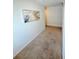 Hallway featuring neutral carpet, white walls, and an abstract art piece at 1158 Sand Torch, Davenport, FL 33837