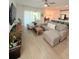Bright and airy living room featuring a comfortable sofa, neutral decor, and sliding glass doors to the patio at 1158 Sand Torch, Davenport, FL 33837