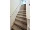 Carpeted staircase with white walls and handrail leading to the upper level at 1158 Sand Torch, Davenport, FL 33837