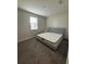 Bright bedroom featuring a comfortable bed and neutral decor at 122 Macaulays Cv, Haines City, FL 33844