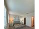 Main bedroom with plush gray upholstered bed and window blinds at 122 Macaulays Cv, Haines City, FL 33844