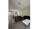 Open living room and kitchen with dark gray tile floors at 122 Macaulays Cv, Haines City, FL 33844