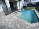 Inviting pool area with paver deck and safety fence at 122 Macaulays Cv, Haines City, FL 33844