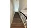 Staircase with gray carpeting and dark metal railing at 122 Macaulays Cv, Haines City, FL 33844