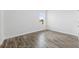 Empty bedroom with wood-look tile flooring and an open door at 127 Dorchester Ct, Kissimmee, FL 34758