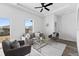 Living area with gray sofas, glass coffee table, and ceiling fan at 127 Dorchester Ct, Kissimmee, FL 34758