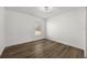 Well-lit bedroom with wood-look flooring and window at 13404 Sw 60Th Court Rd, Ocala, FL 34473